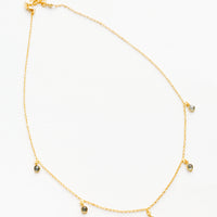 1: Yellow gold chain necklace with 5 small dangling white gemstones.