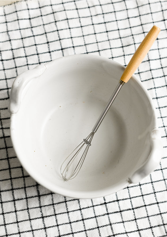 1: A white ceramic bowl with top handles that fit included whisk.