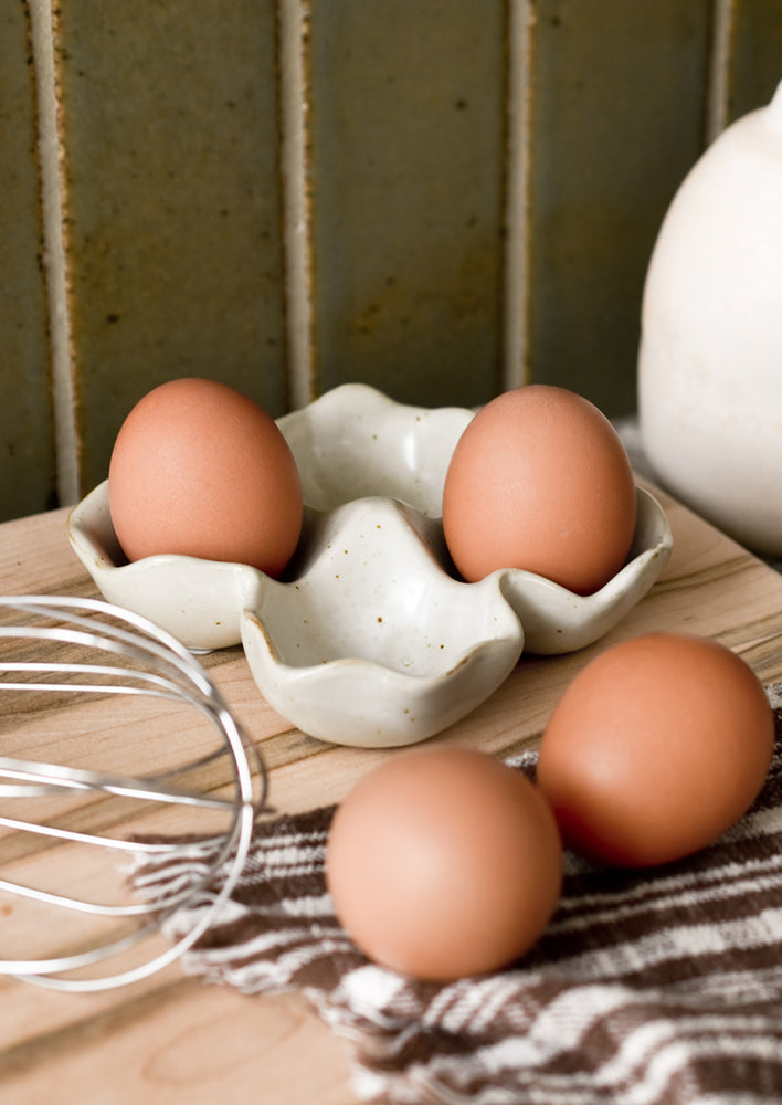 1: A ceramic egg holder on a kitchen counter.