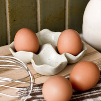 1: A ceramic egg holder on a kitchen counter.