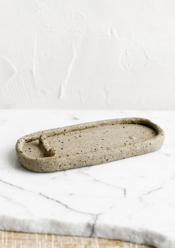 An oval shaped ceramic dish for burning palo santo.