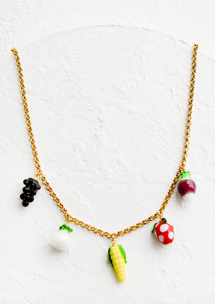 1: A gold chain necklace with glass fruit and veggie charms.
