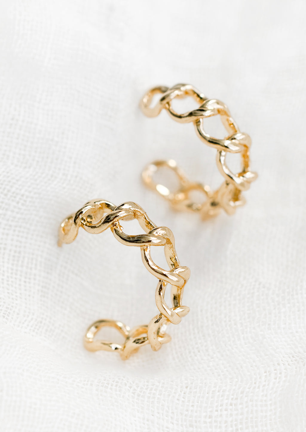 Gold: A pair of chainlink hoop earrings in gold.
