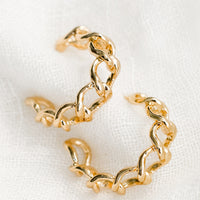 1: A pair of chainlink hoop earrings in gold.