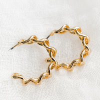 2: A pair of chainlink hoop earrings in gold.