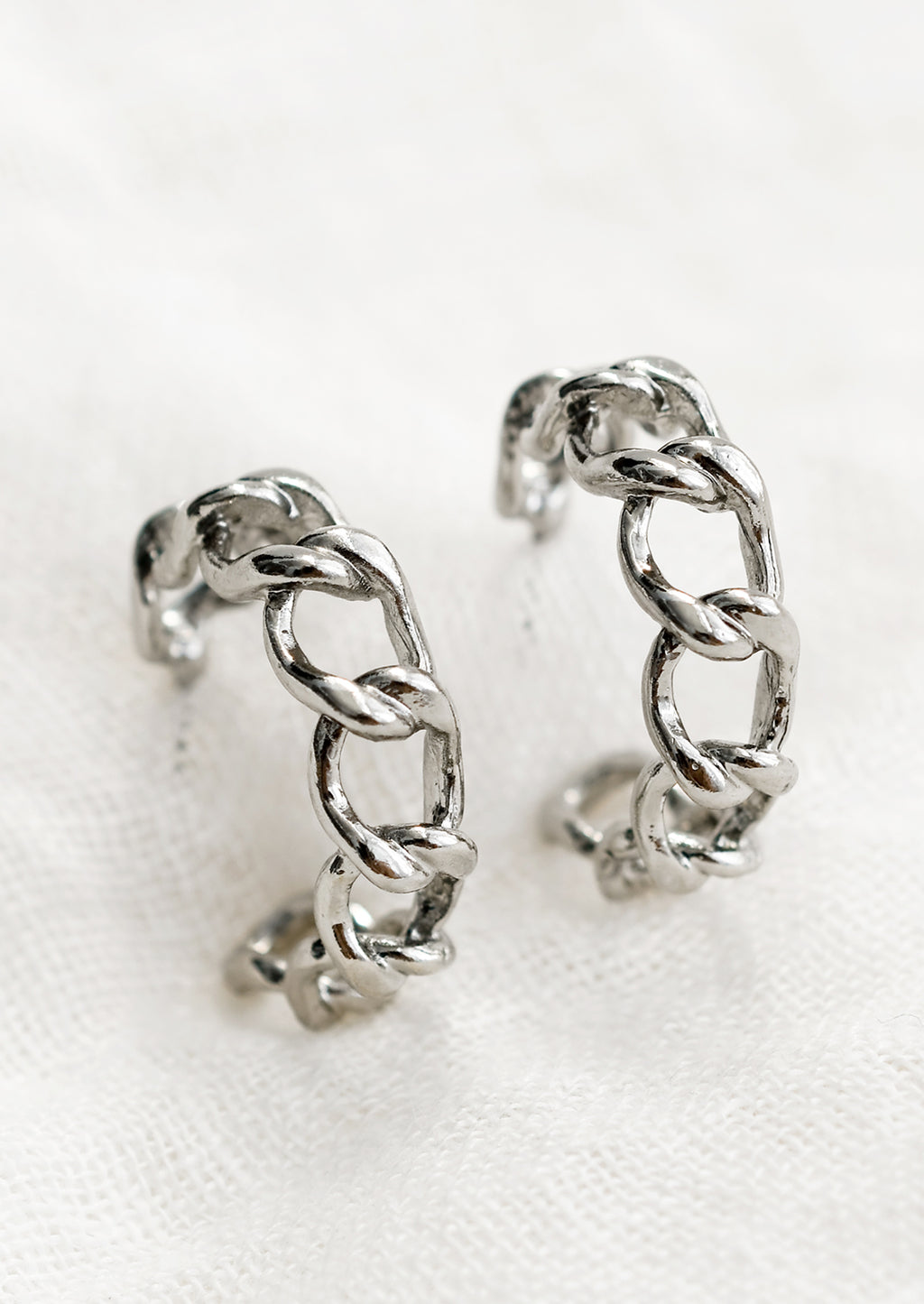 Silver: A pair of chainlink hoop earrings in silver.