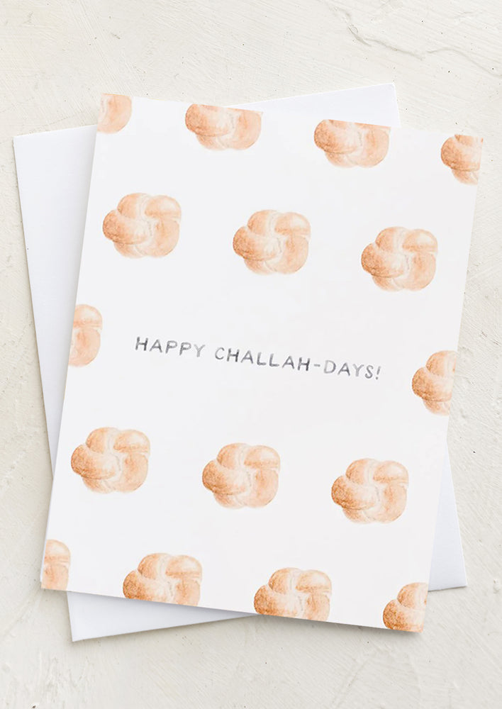 1: A greeting card with illustrations of challah bread and text at center reads "Happy Challah-Days!"