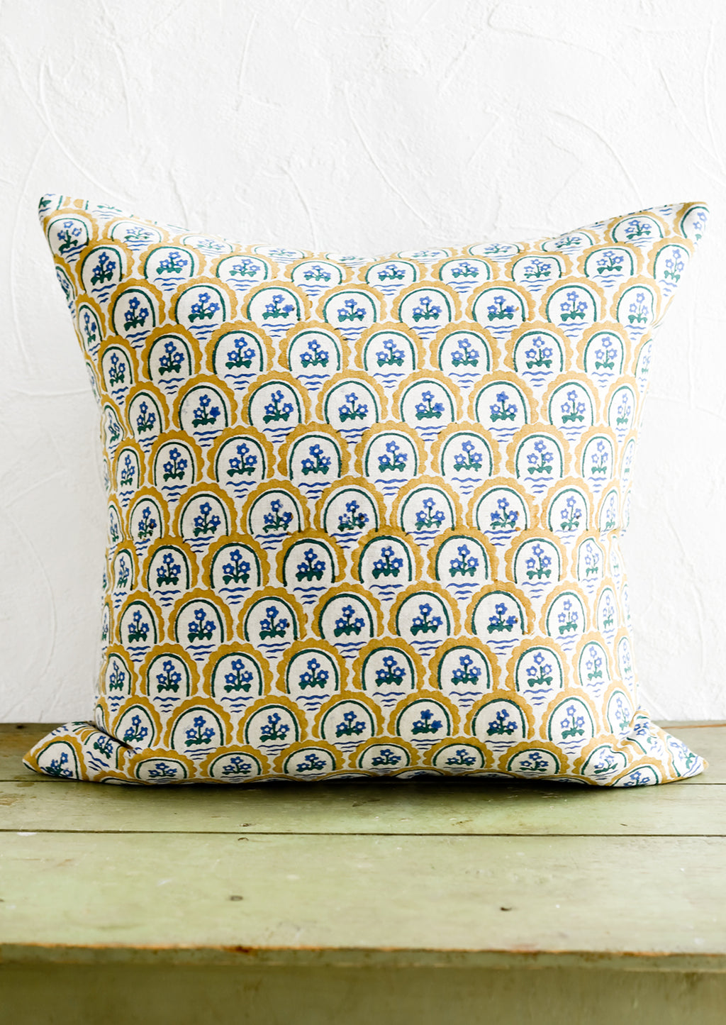 2: A block printed pillow with yellow and blue floral motif.