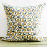 2: A block printed pillow with yellow and blue floral motif.