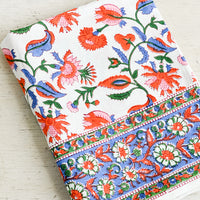 1: A colorful block printed cotton tablecloth folded on a table.