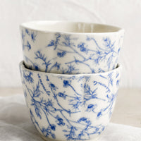 2: A blue and white cup with floral pattern.