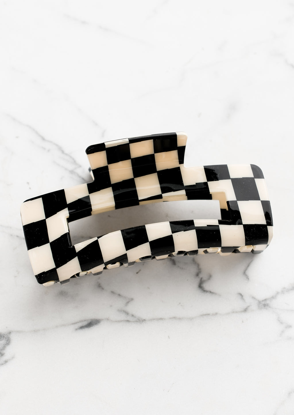 Black: A checker print hair claw in black and ivory.
