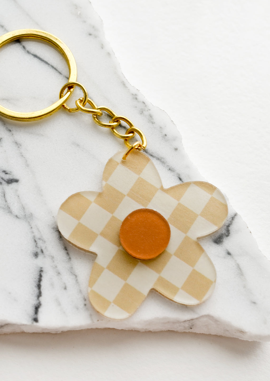 Beige Multi: Flower shaped keychain in beige checker print.