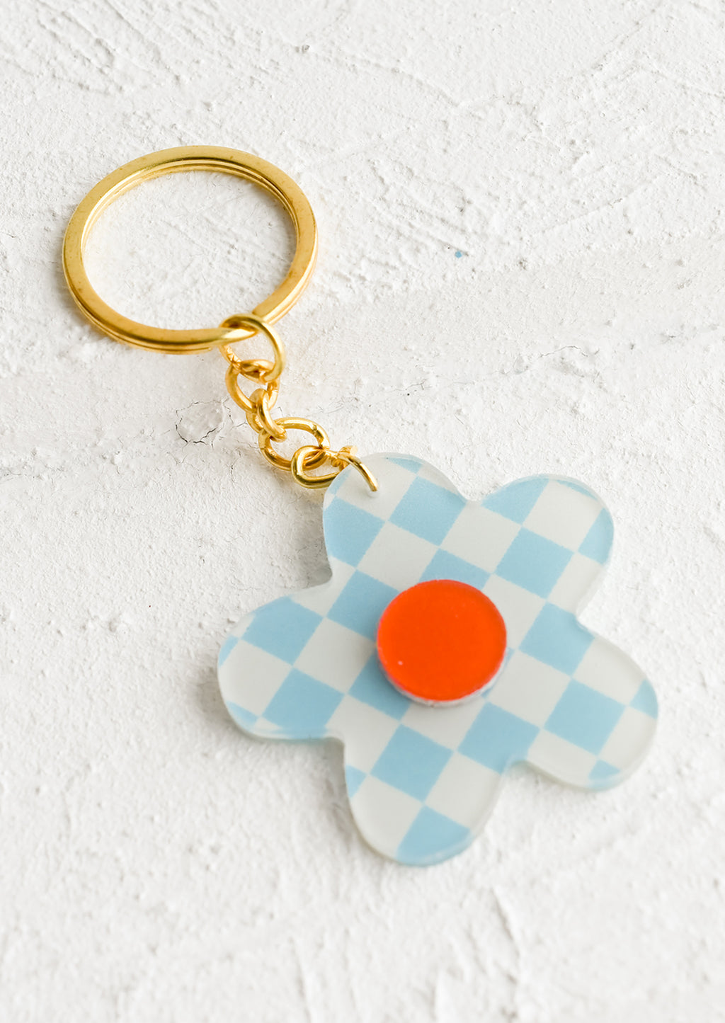 Sky Blue Multi: A flower shaped keychain in sky blue checker print with red center.
