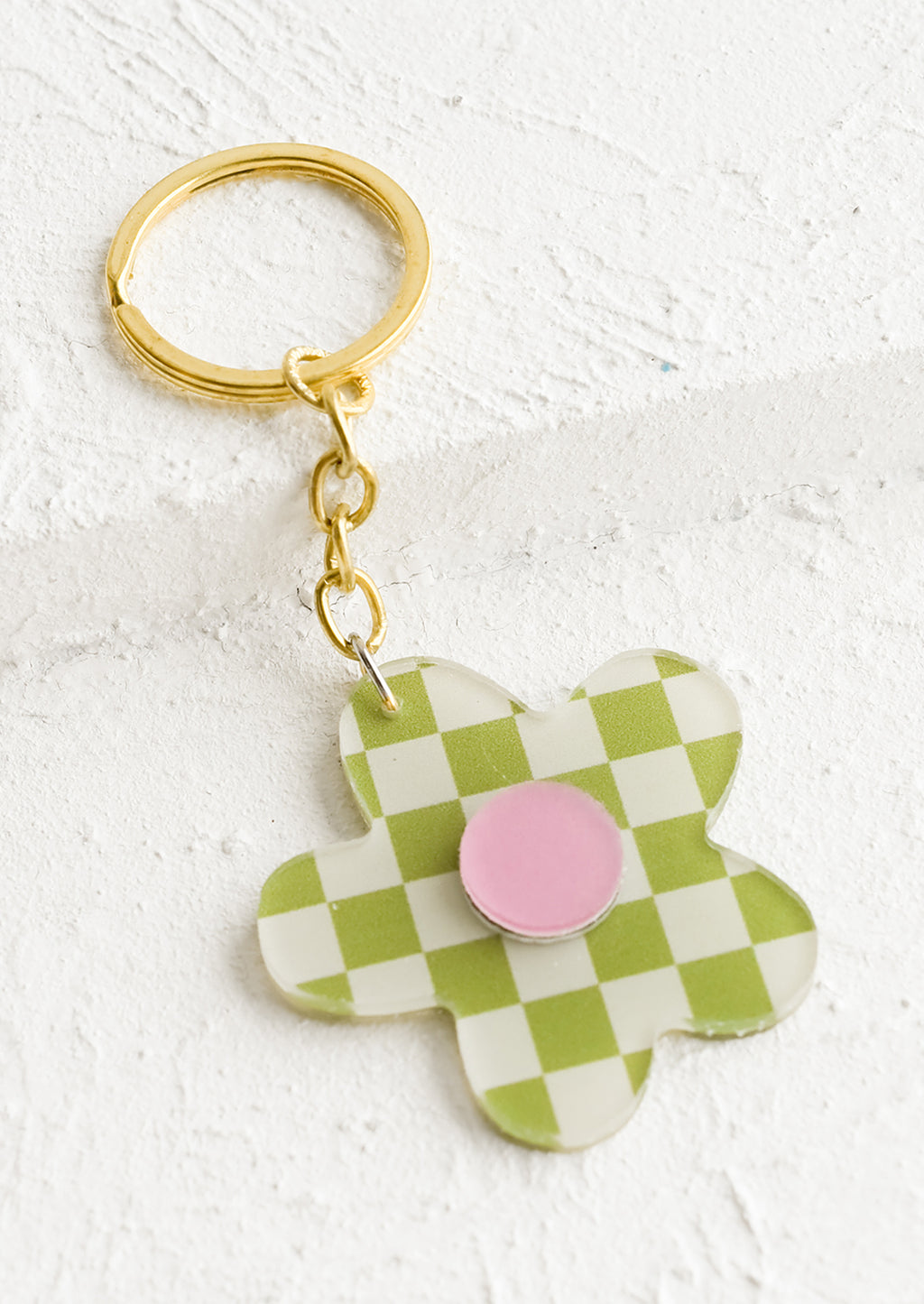 Lime Multi: A flower shaped keychain in green checker print with pink center.