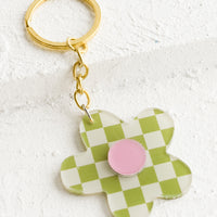 Lime Multi: A flower shaped keychain in green checker print with pink center.