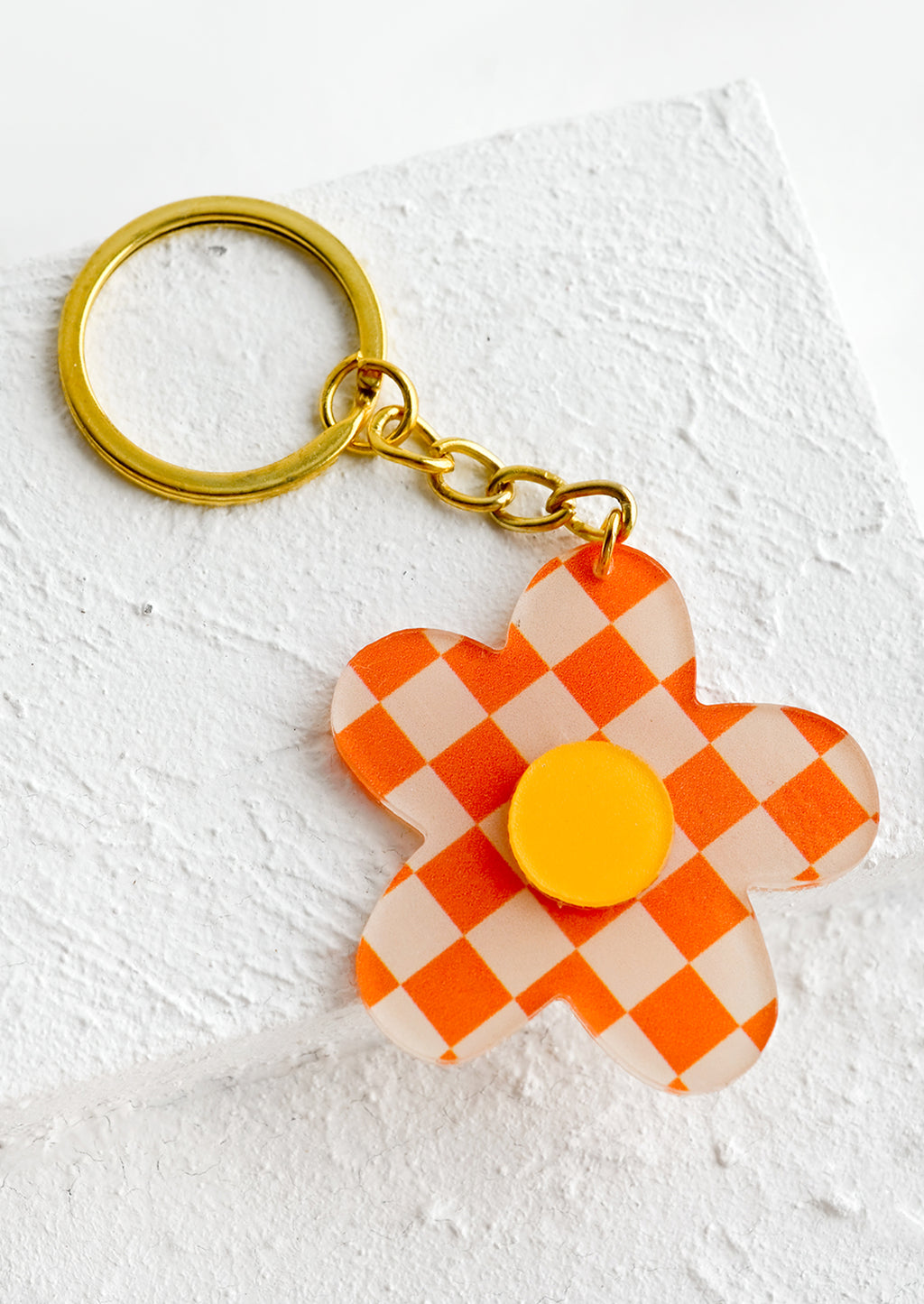 Mandarin Multi: Flower shaped keychain in orange checker print.
