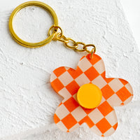 Mandarin Multi: Flower shaped keychain in orange checker print.