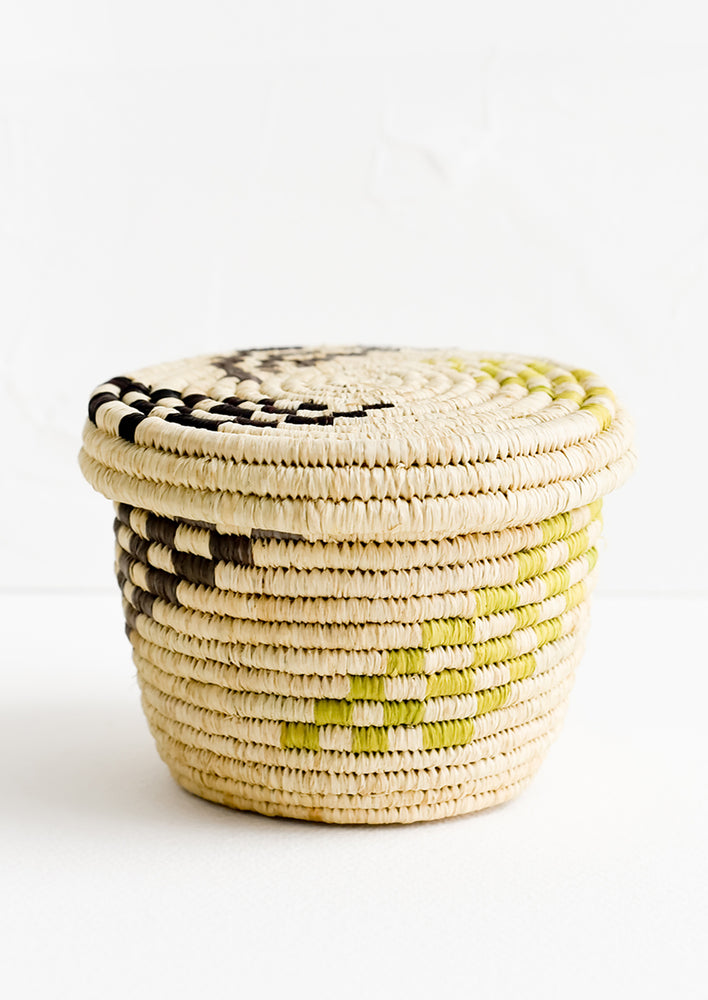 1: A small raffia lidded basket with woven checkered pattern.