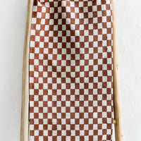 Clay: A linen table runner in clay checker print.