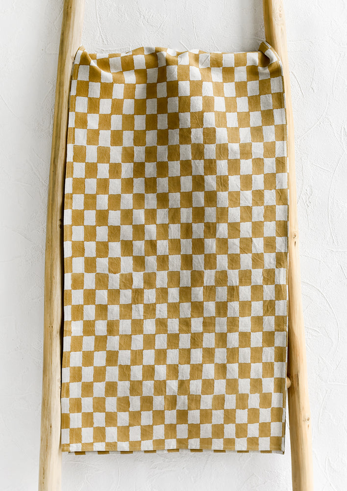 A linen table runner in ochre checker print.