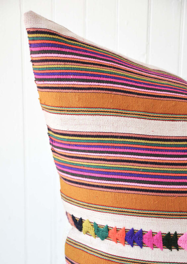A multi-colored stripe pillow.