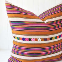 3: A multi-colored stripe pillow.