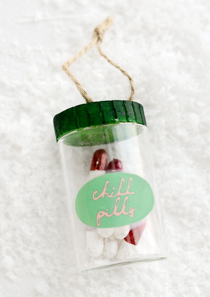 1: Holiday ornament made to look like a pill bottle containing red and white pills with label reading "chill pills".