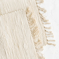 2: Two chindi weave placemats in ivory with tonal fringed trim.