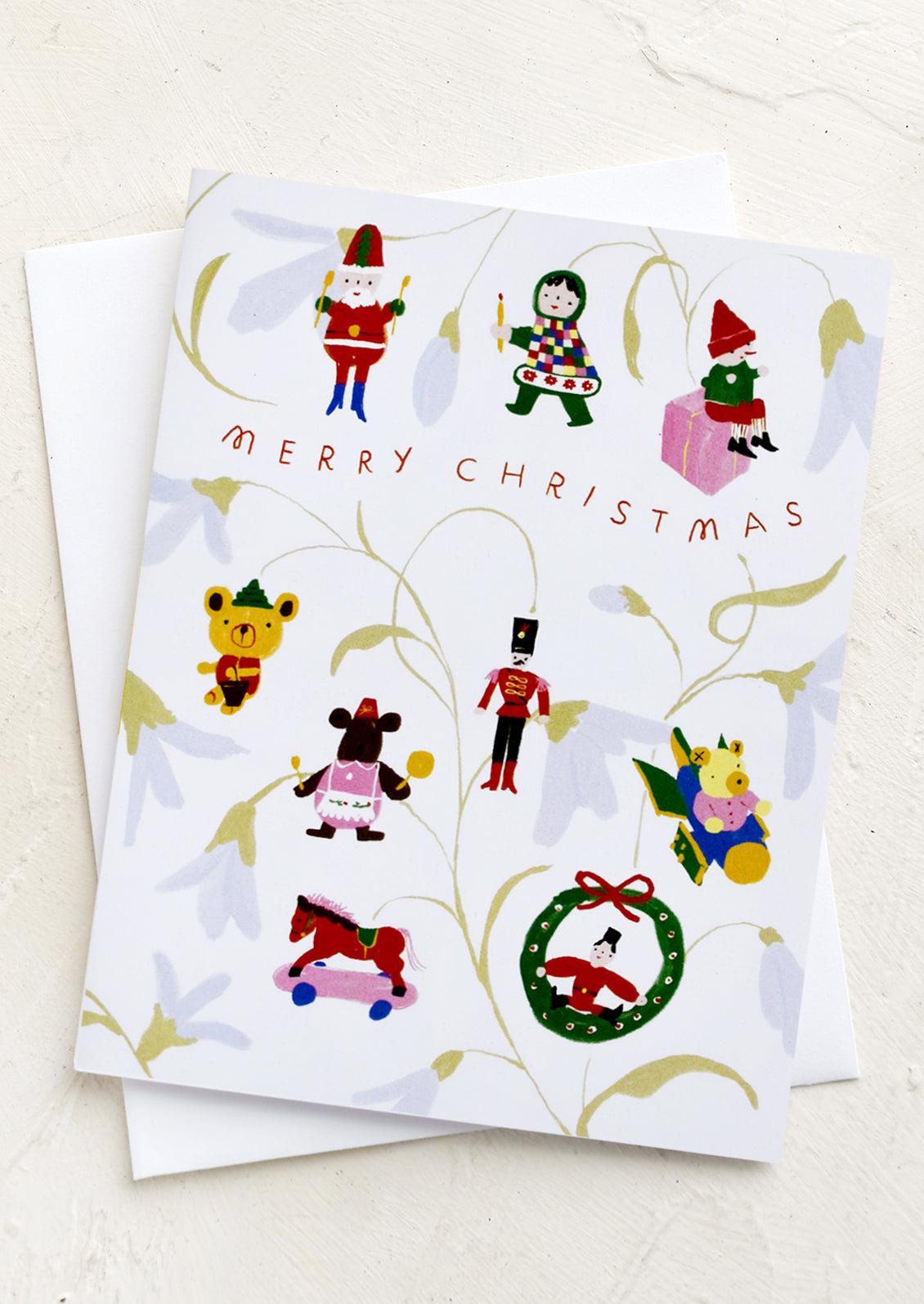 A card with Christmas ornaments hanging from branches, text reads "Merry Christmas".
