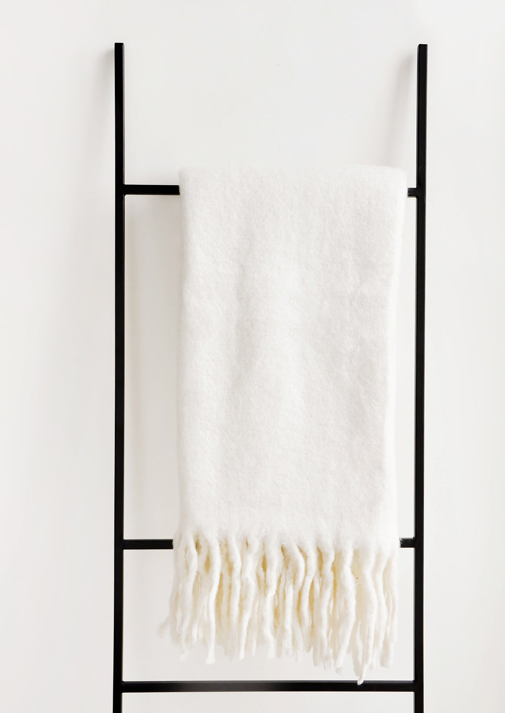Supernatural: Plush and wooly white throw blanket with exaggerated fringe trim