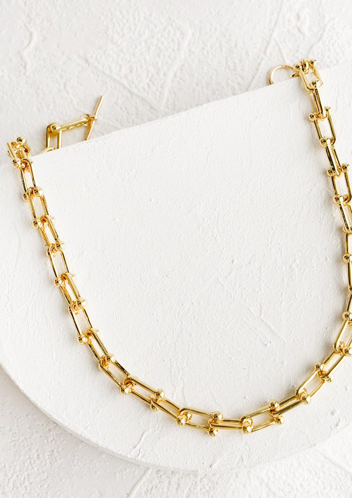 A chunky chainlink necklace in gold.