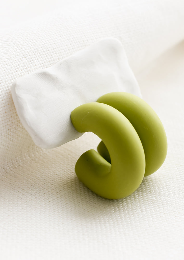 2: A pair of polymer clay hoop earrings in green apple.