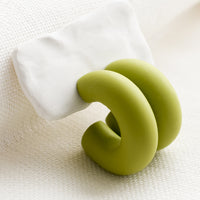 2: A pair of polymer clay hoop earrings in green apple.
