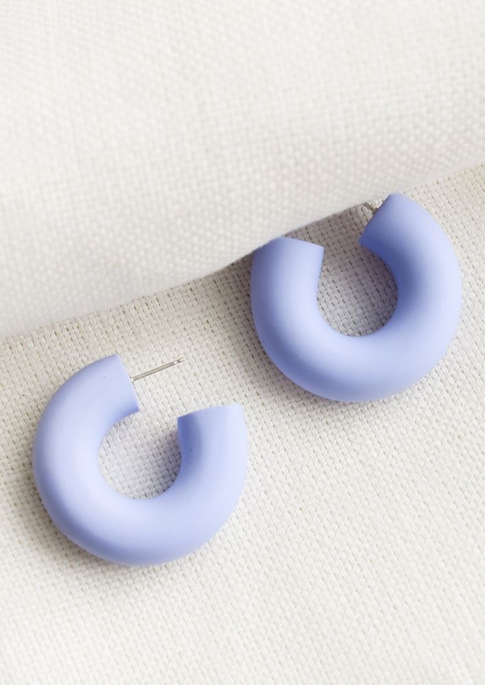 A pair of polymer clay hoop earrings in lavender.