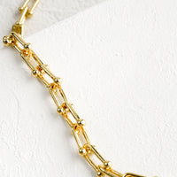 2: A chunky chainlink necklace in gold with toggle closure.