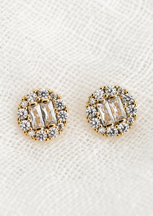A pair of circle shaped stud earrings with baguette pave crystals.