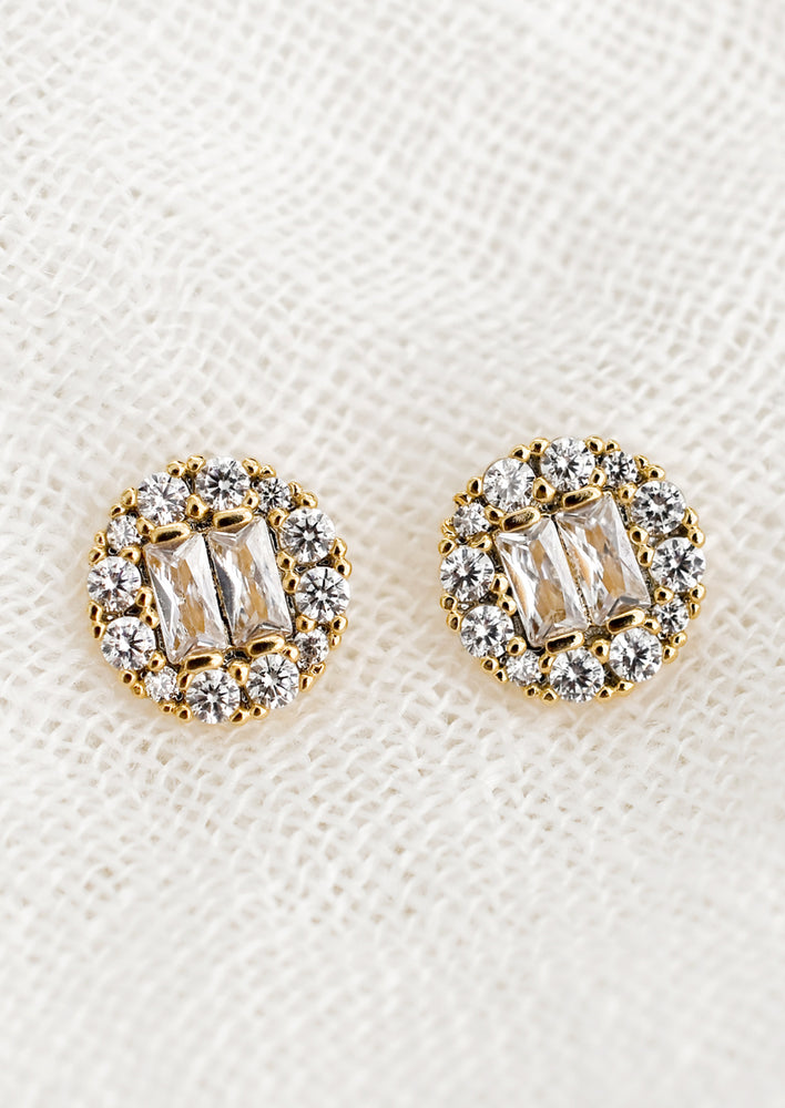 1: A pair of circle shaped stud earrings with baguette pave crystals.