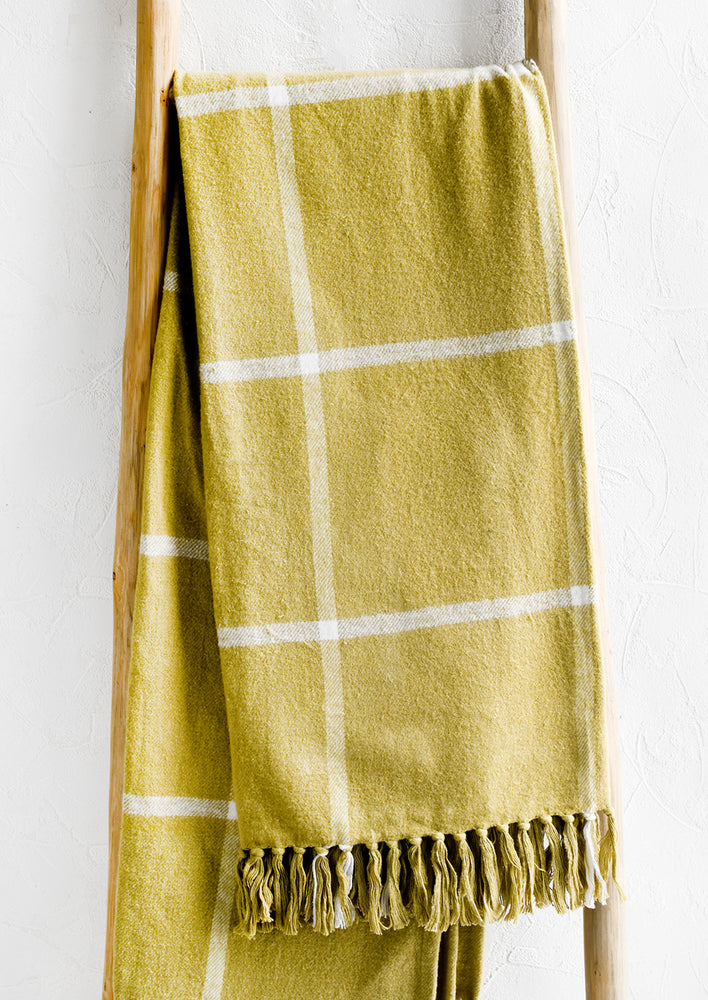 1: A chartreuse blanket with white windowpane pattern.