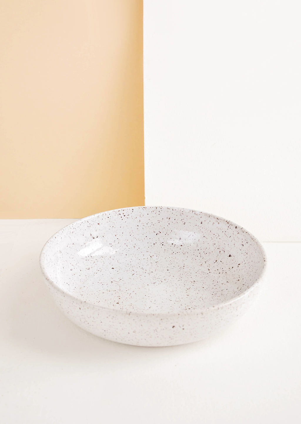 Pasta Bowl [$58.00]: Shallow ceramic bowl, ideal for pasta, in white glaze with brown speckles.