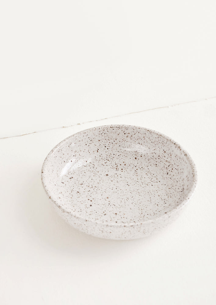 Shallow ceramic bowl, ideal for salad, in white glaze with brown speckles.