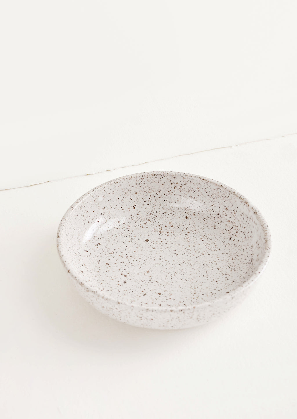 Salad Bowl [$48.00]: Shallow ceramic bowl, ideal for salad, in white glaze with brown speckles.
