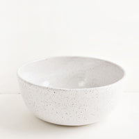 Serving Bowl [$98.00]: Hearty ceramic bowl, ideal for serving or mixing, in white glaze with brown speckles.