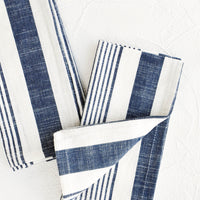 1: White and blue striped cotton napkins, pictured folded as a pair.