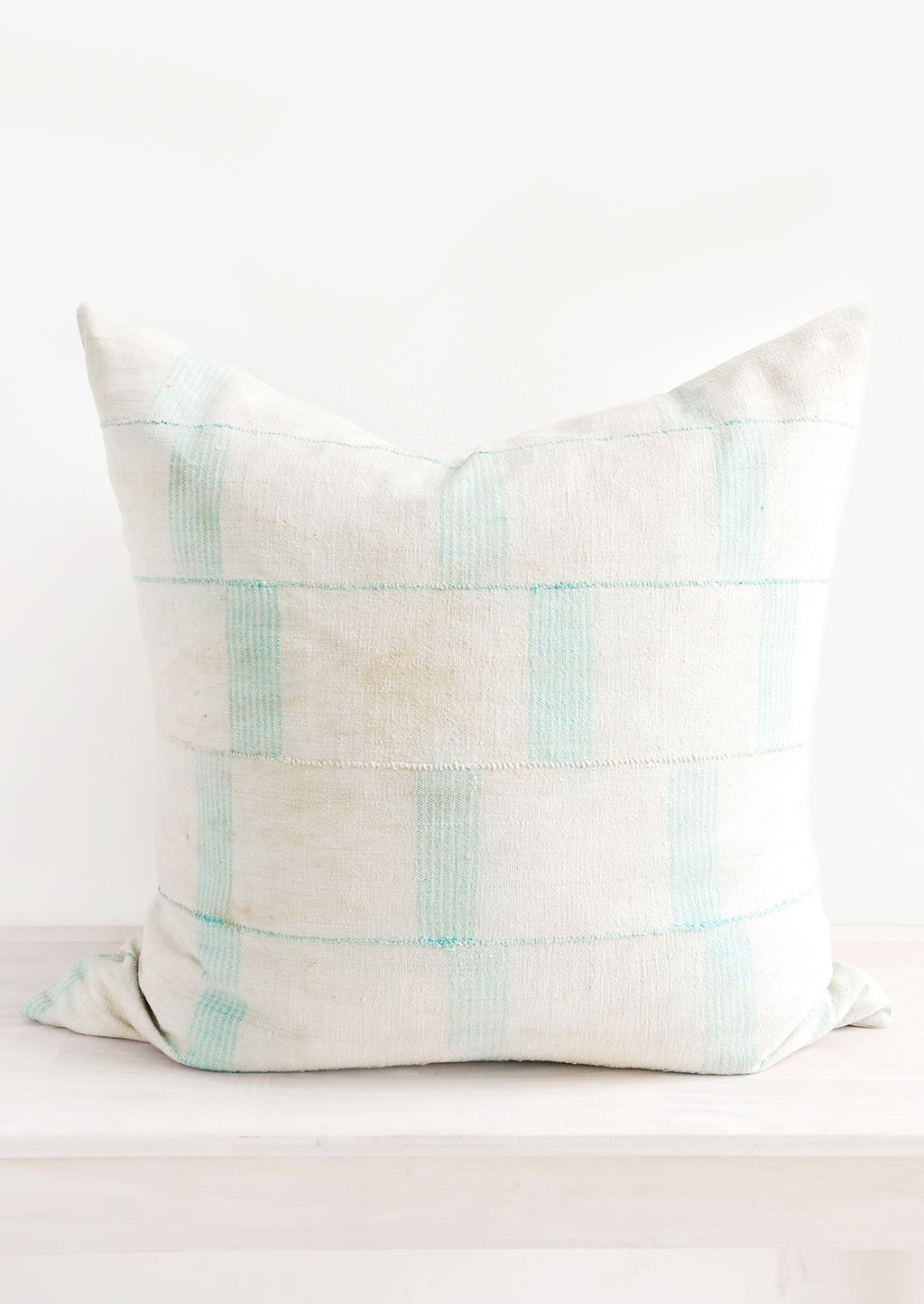 1: Square throw pillow in faded vintage fabric with vertical line print