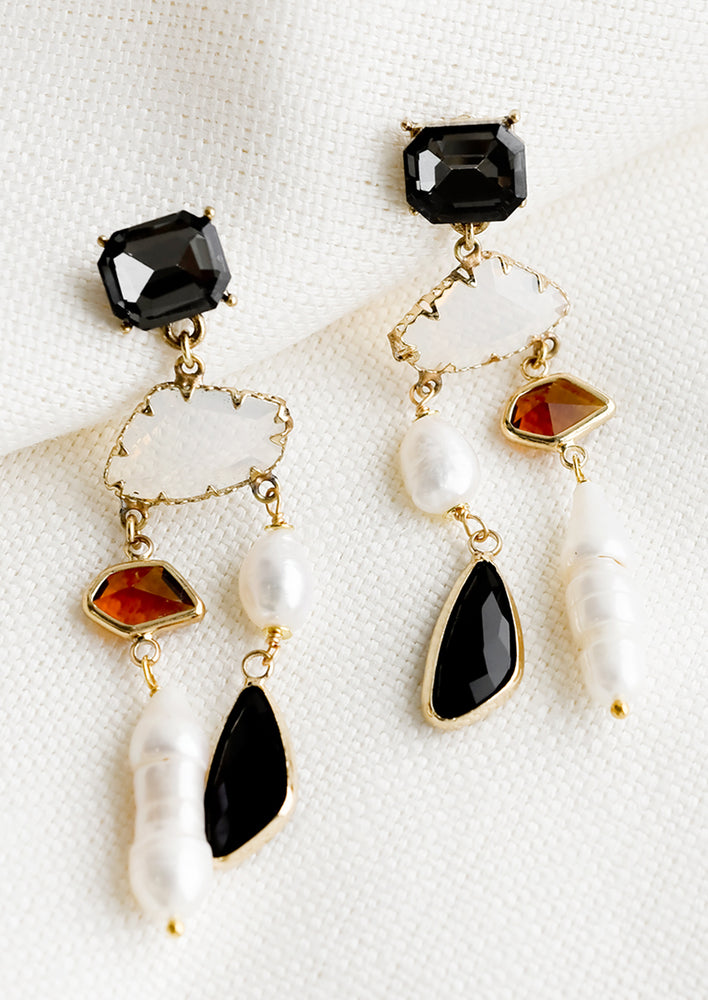 A pair of dangly earrings with gemstone and pearl mix.