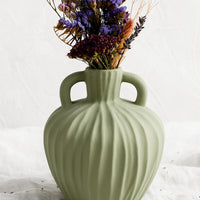 1: A mint green ceramic vase with handles at sides and carved line texture.