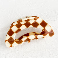 Tobacco: A cloud shaped hair claw in brown and white checker print.