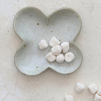 4: A clover shaped little dish in speckled white ceramic.