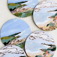 Coastal Landscape: A set of six printed round coasters in coastal print.
